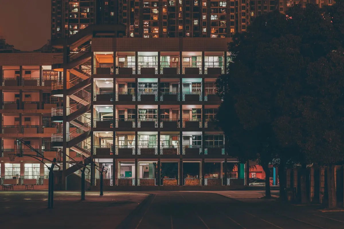 Apartment building at night for real estate investing tips